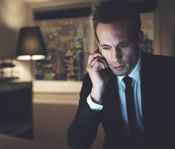 Picture of Financial Advisor on Phone in Hotel Room