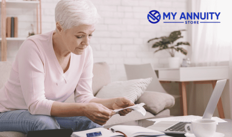 2021 RMD requirements Q&Aretired woman in pink sweater working on finances in living room