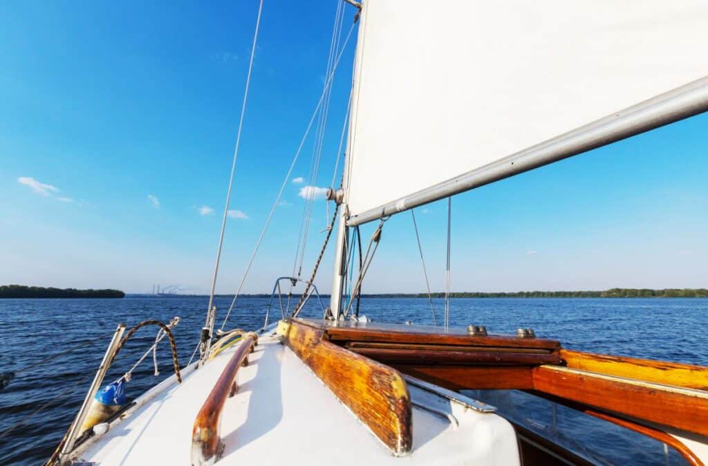 How much money do i need to retire? Picture of white yacht on water with my annuity store, inc. Logo on white sail.