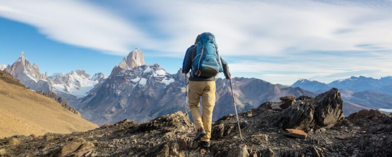 Spectrum Credit Union CD Rates and Review male hiker standing on mountain